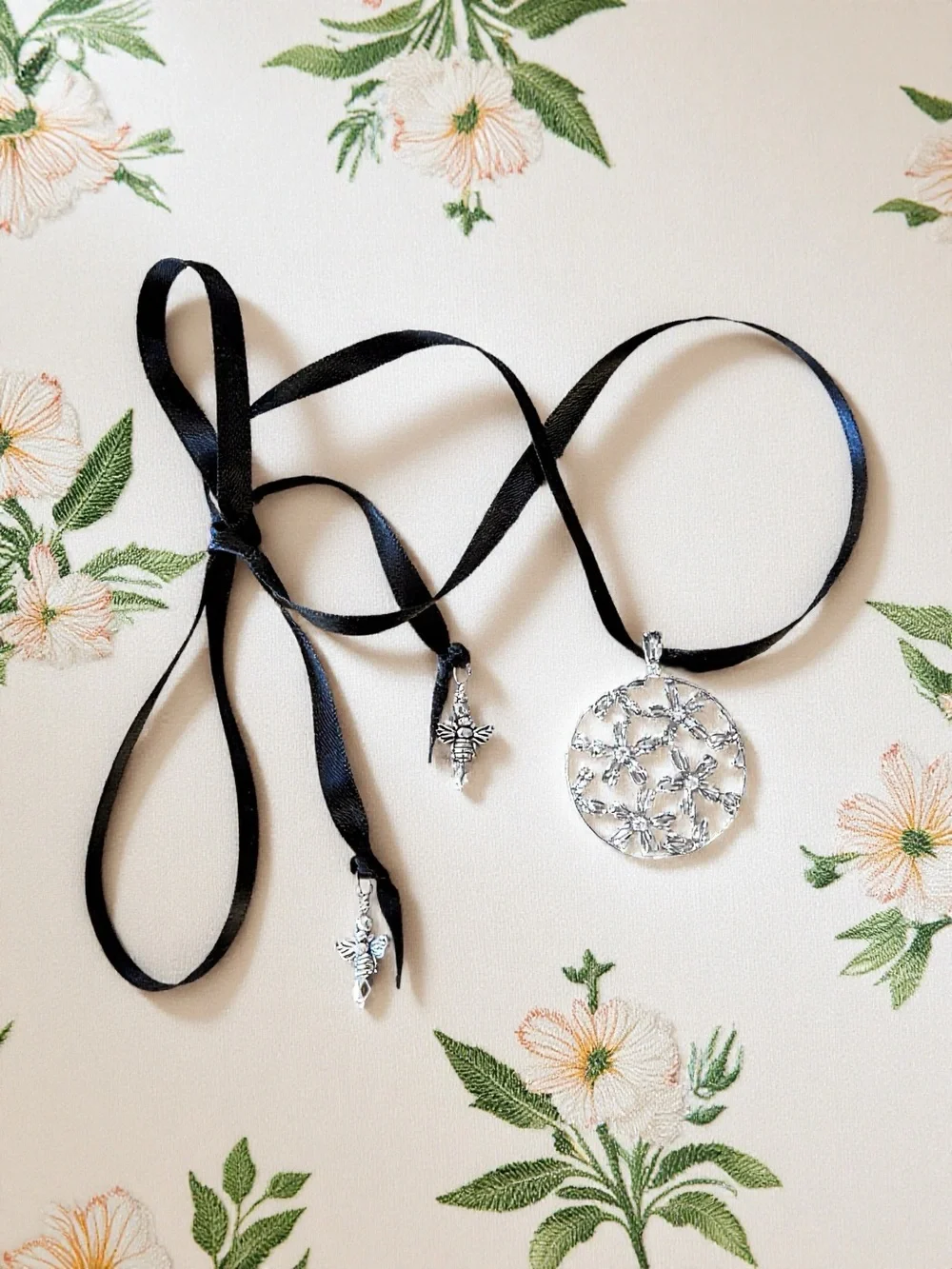 Silver Toned Floral Cutout Pendant Necklace on Black Satin Ribbon